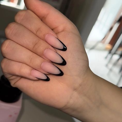 Black Almond Nails with a French Tip Twist 🖤🤍 A modern take on a classic. These black almond nails with a white French tip are chic and timeless. #frenchtipnails #blacknails #almondnails #nails #nailart #manicure #pedicure #nailinspiration #naildesigns #beauty #fashion #style Almond Nails Black French Tip, Matte Black French Tip Nails, Black French Almond Nails, Black Tipped Nails, Almond Black French Tip Nails, Black Almond Shaped Nails, Black French Tip Nails Almond, Matte French Tip Nails, Black Almond Nails