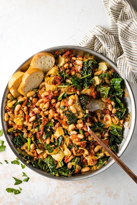 A Tuscan White Bean Skillet is the ultimate way to change up your easy weeknight meals! Great flavors from garlic, sun-dried tomatoes, and artichoke hearts, and easy to make in under 30 minutes! Perfect easy vegetarian meal. White Bean Skillet, Tuscan White Bean, Easy Skillet Meals, High Protein Dinner, Protein Dinner, Meatless Dinner, Vegetarian Dinners, White Bean, Vegetarian Recipes Easy