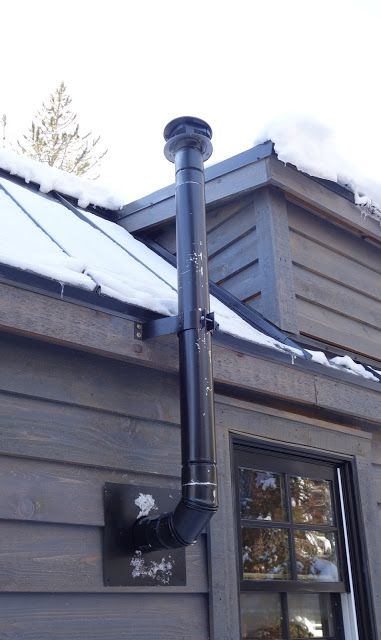 Here you can see the thimble installed. It allows the pipe to pass through the wall but keeps all combustibles far enough away to be safe. Hence the large hole in the wall. Diy Indoor Wood Burning Stove, Wood Stove Installation Wall, Wood Stove Chimney Ideas, Wood Stove Pipe Through Wall, Garage Wood Stove, Wood Stove Pipe, Outdoor Wood Stove, Corner Wood Stove, Wood Stove Installation