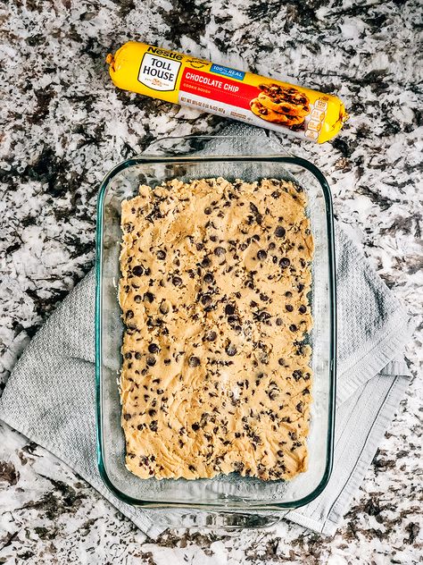 Step one: Flatten chocolate chip cookie dough into bottom of a baking pan. Cookie Bottom Dessert, Recipes With Premade Cookie Dough, Tollhouse Cookie Dough Recipes, Cookie Bars With Premade Dough, Chocolate Chip Cookie Crust Dessert, Recipes Using Cookie Dough, Refrigerated Cookie Dough Recipes, Pillsbury Cookie Dough Recipes, Cookie Crust Dessert