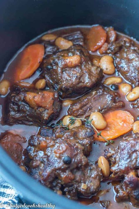 This fall-off-the-bone Jamaican Oxtail Stew braised with butter beans, gravy and classic Jamaican spices simmers away on the stovetop or slow cooker. #jamaicanoxtailstew #butterbeans #slowcookerrecipes Jamaican Oxtails, Oxtails Recipe, Jamaican Oxtail Stew, Oxtail Recipe, Jamaican Oxtail, Oxtail Stew, Oxtail Recipes, Jamaican Dishes, Girl Cooking