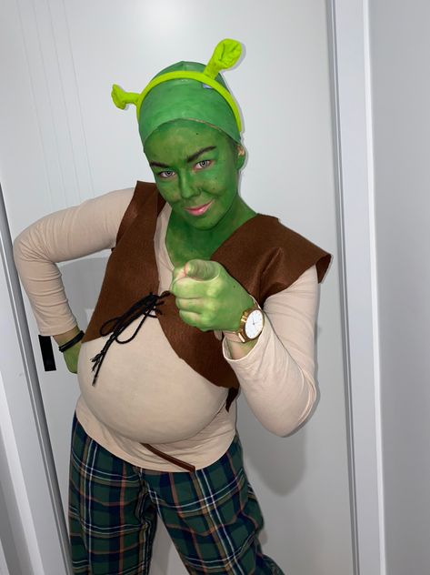 Girl with green face, green checked pants and brown shirt and vest  is dressed as Shrek. Shrek Character, Shrek Costume, Shrek, Halloween Costumes, Halloween, Fictional Characters