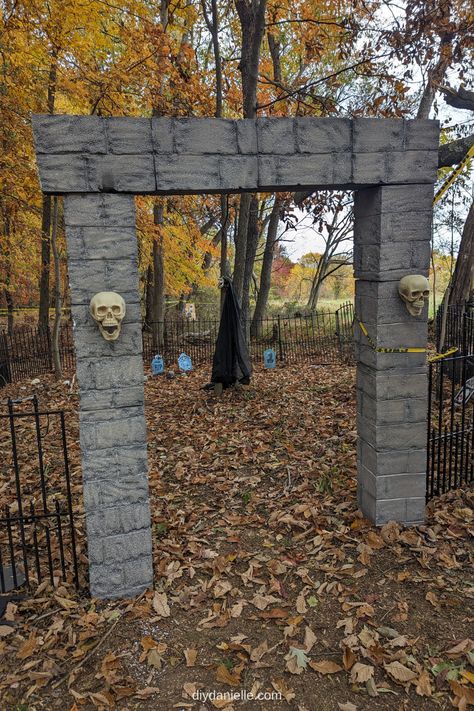 Here is the final picture of the cemetery entrance made of foam blocks and plastic skulls. Because I didn't have them mounted to the ground well (yet), I used caution tape and also fishing line to hold them in place next to the no dig dog fence that I'm reusing. Diy Graveyard, Diy Cemetery, Diy Halloween Graveyard, Cemetery Entrance, Halloween Fence, Cemetary Decorations, Easy Outdoor Halloween Decorations, Spooky Graveyard, Diy Skulls