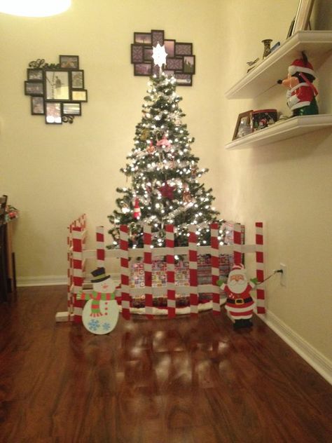 Toddler-Proof Christmas Trees | allmomdoes Christmas Tree Gate, Christmas Tree Fence, Toddler Christmas Tree, Toddler Proofing, Indoor Christmas Decorations, Indoor Christmas, Toddler Christmas, Christmas Tree With Gifts, Diy Christmas Tree