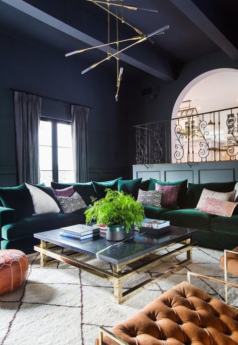 The dramatic den is washed in Farrow & Ball’s Down Pipe paint. The caramel-color leather chairs are from Lawson-Fenning, and the leather pouf is from Morocco | archdigest.com Shay Mitchell House, Purple Living Room, Living Room Wall Color, Room Wall Colors, Green Couch, Design Salon, Green Sofa, Shay Mitchell, Bohol