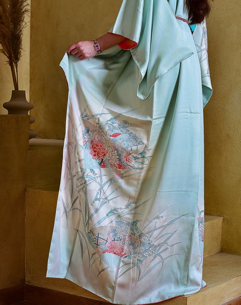 Delicate light sky-blue kimono / kaftan, crafted from 100% mulberry silk adorned with habotai silk lining, meticulously hand-painted by skilled textile artists. Its design is a symphony of Japanese motifs: The Japanese water Iris, known as Shoubu 花菖蒲. Its vibrant purple blooms stand tall and proud and are renowned for the elegant appearance. Blossoming flowers indicate the upcoming season of rain, which is essential for the rice crops. The sparrow, or Suzumeすずめ, is a beloved symbol of joy, f... Water Iris, Rice Crop, Japanese Motifs, Kimono Kaftan, Japanese Water, Habotai Silk, Blue Kimono, Vibrant Purple, Textile Artists