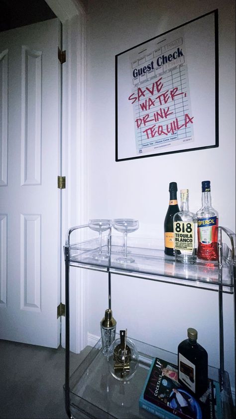 Acrylic bar cart. Save water drink tequila posted. Tire Poster, Aesthetic Bar Cart, Black Bar Cart, Home Sense, Mini Bar At Home, Aesthetic Bar, H Photo, Drink Cart, Nyc Apartment