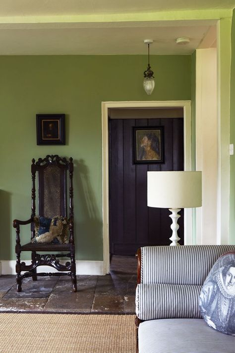 A living room with walls painted in Calke Green - now an archive colour from Farrow Ball. Wood work is White Tie. From 'Decorating with Colour'. Slate floors, green walls painted in Farrow & Ball's Calke Green, antique furnishings. Green Wall Paint Colors, Calke Green, Green Painted Walls, Georgian Interiors, Green Walls, Living Room Green, Green Interiors, Green Rooms, Living Room Pictures