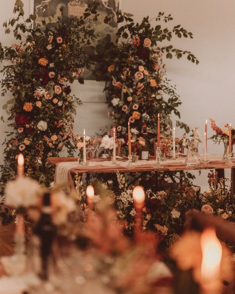 A rich autumnal palette creates for a romantic and modern wedding atmosphere 🍂💫 A canopy of lush foliage, flickering candles, and elegant blooms brought an intimate, cosy atmosphere to life, wrapping the day in timeless romance. Soft neutrals paired with rich burgundies, deep reds, soft peaches, and vibrant oranges - a seasonal colour combo that’s elegant, timeless, and utterly swoon-worthy. The pièce de résistance? The whimsical ceremony arch, beautifully repurposed as a stunning backdro... Bridgerton Fall Wedding Aesthetic, Luxury Autumn Wedding, Silchester Farm, Brown Wedding Flowers, Whimsical Ceremony, Auburn Wedding, Romantic Wedding Florals, Fall Wedding Aesthetic, Autumnal Palette