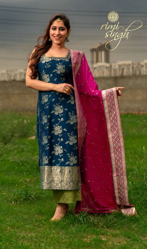 "ARSH" Festive Winter 2019  Prussian blue pure muga banarasi kurta with hand embroidery on the neckline paired with an olive green cotton silk palazzo with sequin work on the pauncha and magenta chinnon chiffon dupatta with hand embroidery. There is antique Banarasi border on the kurta ghera and two sides of the dupatta.  Model & Makeup Sucrita Kukreja Photography @angad kahai singh  Available exclusively at  Rimi Singh Studio A 999 Sushant Lok 1  Gurgaon  #9818310054. Banarasi Kurti Designs Latest Party Wear, Plane Suits With Designer Dupatta, Banarasi Kurti Designs Latest, Silk Kurti Designs, Banarasi Suit, Traditional Blouse Designs, Kurti Designs Latest, Long Kurti Designs, Model Makeup