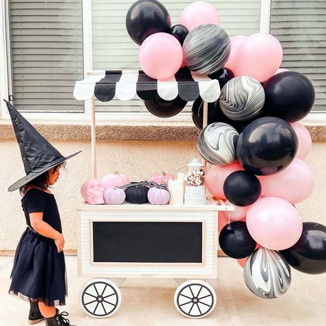 "Create a spooky yet sweet Halloween backdrop with our pink, black, and marble balloon garland kit! It is sure to make a statement at your upcoming Halloween party! Perfect for a classroom Halloween party backdrop or a super-chic adult Halloween party. Balloon colors include: pastel pink, black, and white and black marble.  Everything you need to set up the garland is included: the balloons, balloon tape, and glue dots. You can also opt to add in a balloon pump (highly recommended if you don't a Marble Balloon Garland, Halloween Balloon Arch, Halloween Party Backdrop, String Balloons, Ballon Banner, Marble Balloons, Classroom Halloween Party, Halloween Balloon, Blowing Up Balloons