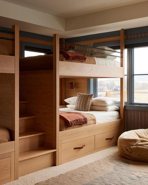 Brown and blue bunk room features built-in brown wood bunk beds flanking a staircase and boasting drawers with brown leather pulls and brown bedding complemented with an orange fringe throw blanket. Bunk Bed Room, Bunk Bed Rooms, Adult Bunk Beds, Bunk Beds Built In, Built In Bunks, Bunk Rooms, Wood Bunk Beds, Bunk Bed Designs, Brown Bed