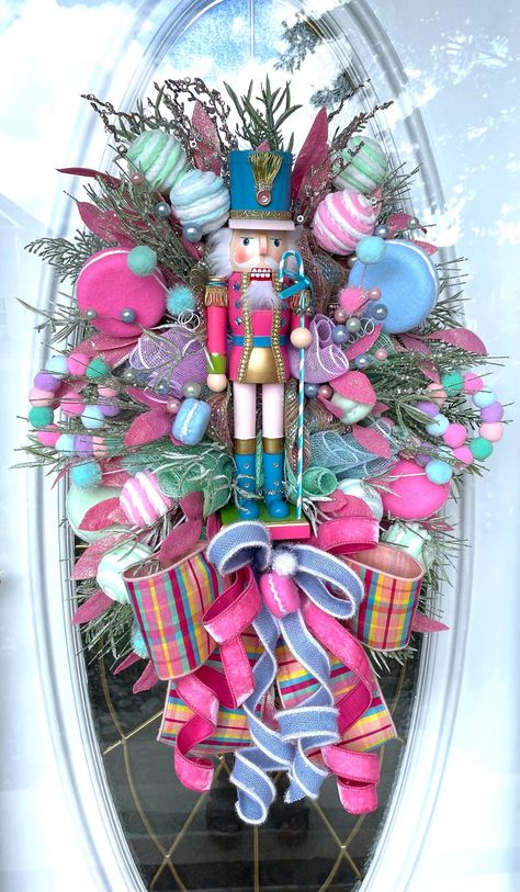 Nutcracker Christmas Bling Wreath, Holiday Pastel Swag, Gift for Her, Christmas Front Door Decoration, Holiday Gift, Sweets Wreath, Christmas Decorating Wood Pink Candy Cane Bling Rhinestone Nutcracker *white swag *premium deco mesh *17" wood pastel Blinged with rhinestones and tiny silver bells on his staff *Glittered pink bay leaf *Pastel Macarons  *Pastel yarn balls *snowy glittered greenery *green glittered pine picks  *Designer ribbon Measures 31"X23"X 8" Ready to ship! If you're happy with Pink Candy Cane Wreath, Nutcracker Ballet Christmas Tree Sugar Plum Fairy, Pastel Color Christmas Decor, Flamingo Christmas Wreath, Pastel Christmas Wreath, Pastel Nutcracker Christmas, Decorating With Nutcrackers Christmas, Nutcracker Wreath Ideas, Pastel Candy Christmas