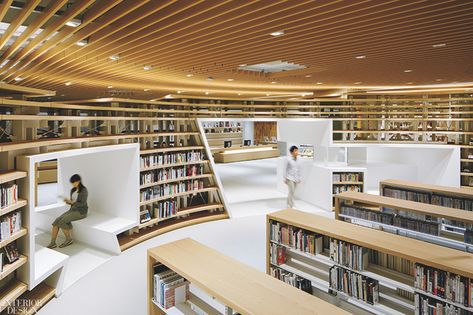 Books tend to be rectilinear. But that doesn’t mean their repositories have to be. For this library in Kumamoto, Japan, design director Kazunobu Nakamura conceived a system of curved shelves to evoke the Kikuchi River, which runs through the city, located on the island of Kyushu. The nearly 330 linear feet of bookcases—composed of steel columns supporting shelves of pale Japanese ash finished with clear urethane—wind through the 18,300-square-foot space, dividing it into discrete nooks. Public Library Design, Interior Design Competition, Detail Arsitektur, Arsitektur Masjid, Library Architecture, Central Library, Steel Columns, Green Architecture, Cultural Architecture