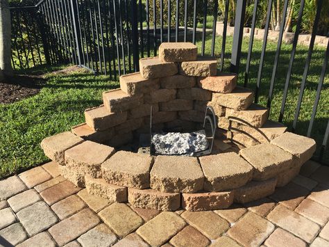 DIY corner fire pit. I used leftover landscape blocks and made a fire pit in an unused area of my patio. Since it was already paved I just laid the blocks down. I added 4 cement flat pavers inside to save my existing pavers should I want to remove or move in the future. A good pressure wash and I was goodto go Corner Fire Pit, Fire Pit Out Of Cinder Blocks, Square Brick Fire Pit, Fire Pit With Cement Blocks, Diy Fire Pit With Red Bricks, Circular Brick Fire Pit, In Ground Fire Pit, Paver Fire Pit, Make A Fire Pit