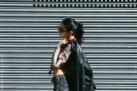 Side view of an alternative woman standing in front a shutter door. by BONNINSTUDIO for Stocksy United Shutter Doors, Photoshoot Concept, Street Fashion Photography, Woman Standing, Fashion Poses, Side View, Model Photos, Shutters, Street Fashion