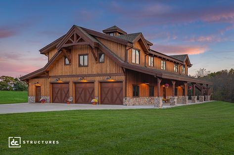 This post and beam home in Dexter, Michigan is 5,075 square feet, plus a 730 sq. ft. covered shed roof and a 438 sq. ft. deck. The first floor features a large garage area with three garage bays and an attached recreation room, along with a storage area and mud room. Heavy timber stairs lead to the second story, where a three-bedroom home with an open-concept living, dining, and kitchen area serves as a stunning showcase of our heavy timber capabilities. Timber Barndominium, Barndominium Ideas Big Garage, Barndominium Large Garage, Timber Frame Garage With Apartment, Barnwood Builders Houses, Barn With Living Quarters, Barn House Kits, Timber Stair, Silo House