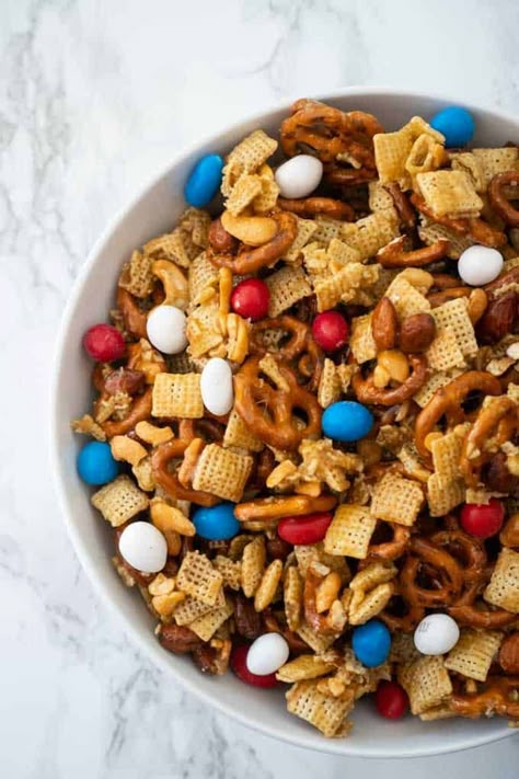 There isn't much better for snacking than this Sweet and Salty snack mix perfect for parties or just snacking at home! Fast, easy party snack recipe. Chex Mix Recipes Sweet 4th Of July, Patriotic Trail Mix Recipe, Patriotic Chex Mix Recipes, Fourth Of July Trail Mix Recipe, Sweet And Salty Mix Recipes, Fourth Of July Chex Mix Recipe, Patriotic Snack Mix Recipes, Chec Mix Recipe Sweet, 4th Of July Trail Mix Recipes