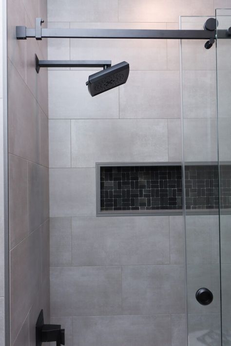 Gray tile shower with black mosaic accent with matte black fixtures. Black Shower Base With Tile Walls, Shower Tile Black, Gray Tile Shower, Matte Black Fixtures, Large Shower Tile, Tiled Showers, Gray Shower Tile, Black Fixtures, Repurposed Headboard