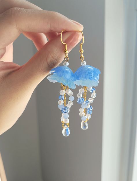 "Add something extra to your outfits with these cute jellyfish earrings! The dangle length is around 7cm/2.7\". It is made with gold wire, shrink plastic, and crystal beads. Each pair is lovingly handmade! 🎀 CARE INSTRUCTIONS 🎀 * Avoid getting your jewelry wet * Avoid perfumes or sprays * Store in a cool, dry place" Shrink Plastic Jellyfish, Jelly Fish Earrings, Jellyfish Earrings Diy, Water Accessories, Jellyfish Jewelry, Handmade Jewelry Wire, Jellyfish Earrings, Cute Jellyfish, Shrink Plastic Jewelry