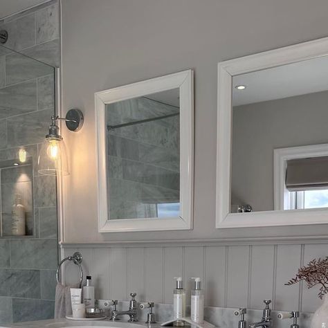 Chloe Dulieu on Instagram: "The master en-suite 🫶🏼

Vanity unit- @burlingtonbathroom 
Taps- @burlingtonbathroom 
Mirrors- @drench.co.uk 
Floor tiles- @mandarinstoneofficial 
Wall tiles- @toppstiles 
Wall lights- @lighting_direct 
Walls painted in Ammonite, panelling painted in Cornforth White @farrowandball 

#bathroominspo #masterensuite #ensuite #bathroom #doublevanity #vanityunit #carraramarble #shaker #woodeffecttiles #bathroomtiles #neutralbathroom #neutrals #renovation #countrymodern #calming #relaxing" Ammonite Panelling, Shaker Bathroom, Cornforth White, Neutral Bathroom, Bathroom Lights, Master Ensuite, Wood Effect Tiles, Ensuite Bathroom, Direct Lighting