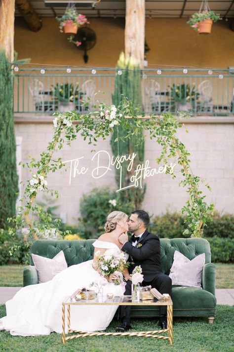 Bride and Groom kissing on a green velvet coach with custom name neon sign backdrop covered in green ivy. South Coast Winery Wedding, Vineyard Wedding Theme, South Coast Winery, Temecula Wineries, Temecula Wedding, Mom Art, Winery Wedding, Winery Weddings, Vineyard Wedding