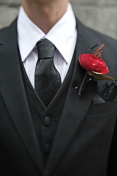 A red floral boutonniere amongst a black suit Wear Wolf, Everything Wedding, Silver Color Palette, Groom Suits, Quinceñera Dresses, Corsage And Boutonniere, Teal Accents, Corsage Wedding, Urban Wedding