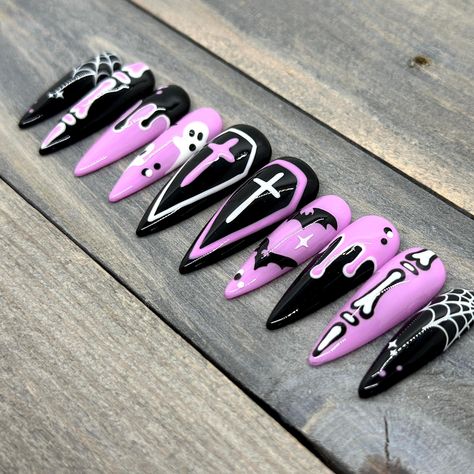 Dawn Witch Designs Unique, re-usable, hand painted, and made in Canada. These luxury press on nails are handmade using high quality gel polish and salon-grade materials.  ✨ PASTEL CREEP ✨  This pastel-goth Halloween set features adorable hand-drawn art in pink, black, and white. The images on one hand compliment the ones on the other with mirrored colours. This makes for a visually sumptuous set that will be a guaranteed conversation-starter! Due to the number of images and details on each nail, Goth Nails Halloween, Pastel Goth Nails Short, Hot Pink And Black Halloween Nails, Planchette Nails, Pastel Witch Nails, Halloween Goth Nails, Pink Black Halloween Nails, Black Nails With Pink Design, Spooky Pink Nails