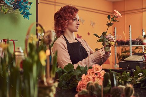 Charming redhead female florist wearing uniform making a beautiful flower composition by fxquadro. Charming redhead female florist wearing uniform making a beautiful flower composition while standing at the counter o... #Sponsored #florist, #wearing, #uniform, #Charming Flower Composition, Photography Backgrounds, A Beautiful Flower, Background For Photography, Beautiful Flower, Flower Shop, Florist, Beautiful Flowers, Composition