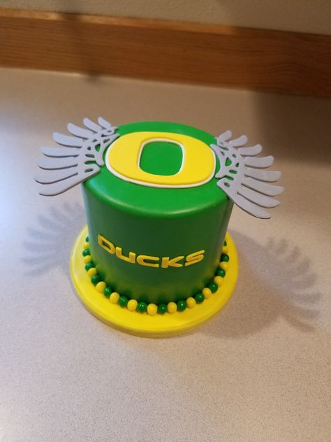 A Oregon Ducks cake for a guy's birthday. Mallard Duck Birthday Cake, Duck Hunting Birthday Cakes For Men, Yellow Duck Cake, Oregon Ducks Party, Yellow Duck Cupcakes, Hockey Birthday Cake, Alien Cake, Bird Cage Cake, Peanut Cake