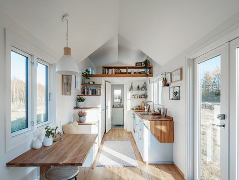 Kitchen, Wood Counter, Range, White Cabinet, Wood Backsplashe, Drop In Sink, Ceiling Lighting, and Light Hardwood Floor Vilde features plenty of windows so as to flood the interior with sunlight and connect the home to the natural landscape. Chic Shack, Pre Fab Tiny House, Tiny House Interior Design, Tiny House Loft, House Loft, Tiny House Inspiration, Tiny House Kitchen, Built In Furniture, Tiny House Decor