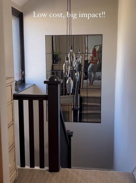 I was tired of my staircase so I gave it a glow-up with cheap Amazon buys - it looks posh & the space is brighter too | The Sun Stair Case Mirror, Staircase Mirror Wall, Staircase Mirror, Landing Stairs, Mirror Collage, Foyer Stairs, Stick On Mirror, Huge Mirror, Stairs Design Interior