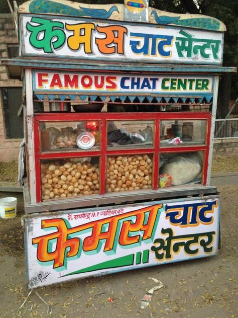 Colourful street food stall Indian Street Food Stall Design, Delhi Aesthetics, Paani Puri, Chor Bazaar, Street Food Stall, Desi Design, Stall Decorations, Food Stall Design, Stall Signs