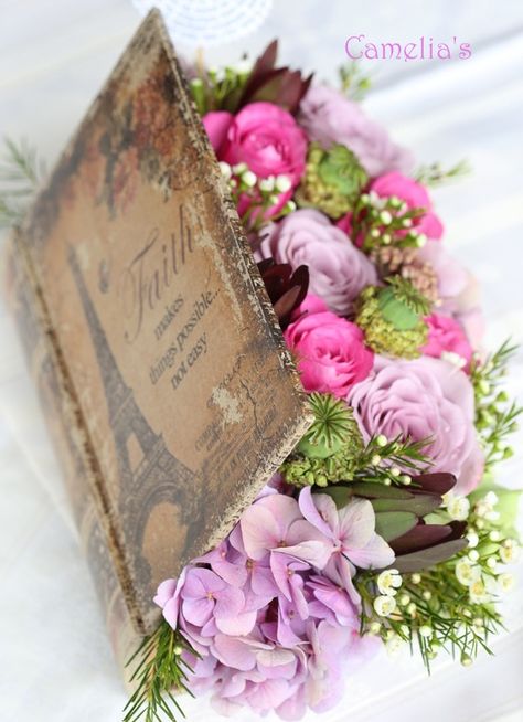 Cool Idea....with your love of books Cassidy, we could hollow out old books, make them look vintage and put a flower arrangement in them.  So different....but so cool...add pearls and bling..... A Table, Pink Flowers, Flowers, Pink, White