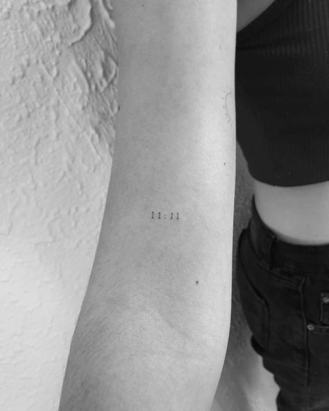 "11:11" lettering tattoo on the bicep. 11:11 Tattoo Placement Ideas, 11 11 Small Tattoo, Tiny 11:11 Tattoo, Dainty 11:11 Tattoo, 1111 Tattoo Placement, 11 11 Tattoo Finger, 11:11 Fine Line Tattoo, 11:11 Red Tattoo, 11 11 Wrist Tattoo