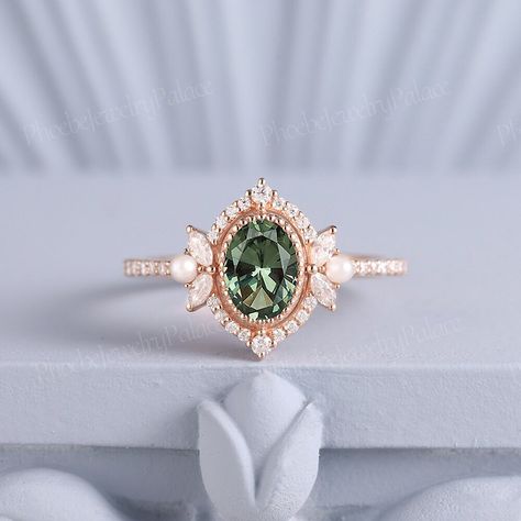 Vintage Oval Green Sapphire Pearl Engagement Ring Art Deco Filigree Solid Gold Wedding Ring Unique Birthstone Ring Anniversary Gift Handmade PRODUCT SUMMARY Metal Type: yellow, white or rose solid 14 or 18k gold. Size: All sizes are available, contact me if they do not contain the size you want in the drop-down menu. ☪☪Engagement ring ⚜Center Stone - Lab Grown Olive Green Sapphire Cut - Oval Size - 7x5mm ⚜Side Stone - Moissanite Cut - Round Weight - 0.33ct Clarity - SI-VS Color- G-H ⚜Band width - 1.8mm IMPORTANT INFORMATION  ☪Shipping ⚜It usually takes 2-3 weeks for production and 2-5 days for shipping to most US destinations. Free shipping within US. ⚜If you want to receive your ring sooner, rush order and shipping upgrade services are available. ☪Engraving You can order a custom engravin Gold Gemstone Wedding Rings, Gold And Emerald Wedding Ring, Art Deco Ring Engagement, Subtle Engagement Rings, Oval Vintage Engagement Ring, Wedding Ring Pearl, Green Wedding Ring, Peridot Wedding Ring, Green Engagement Ring