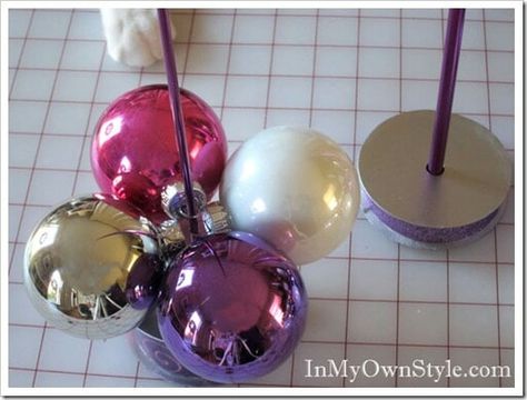 How to make a table top Christmas tree using a round ball ornaments and a knitting needle. When the holidays are over, it easily comes apart so you can store it with ornaments. #ChristmasDecorDIY #ChristmasOrnaments #ShinyBrites ##ChristmasTrees #EasyChristmasDecorations Christmas Balls Decorations, Christmas Tree Decorations Diy, Christmas Tabletop, Easy Christmas Decorations, Lace Doily, Navidad Diy, Christmas Projects Diy, Knitting Needle, Christmas Ornament Crafts