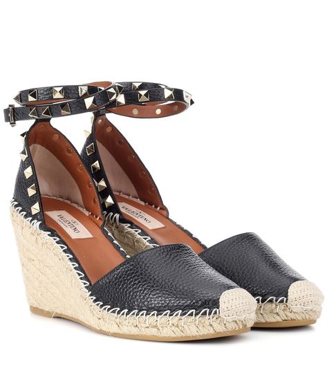 Valentino - Valentino Garavani Rockstud Double leather wedge espadrilles - Valentino Garavani's signature studs in a pale gold hue add instant appeal to any accessory, and on a wedge espadrille these embellishments look especially fresh. Crafted in Italy from black leather, this statement summer style sits atop a woven wedge platform and features an ankle strap for comfort. Wear with jeans and seasonal stripes for a new-season take on warm weather dressing. seen @ www.mytheresa.com Valentino Wedges, Valentino Rockstud Sandals, Valentino Heels, Valentino Garavani Shoes, Black Leather Wedges, Wedge Espadrilles, Black Espadrilles, Valentino Rockstud, Pale Gold