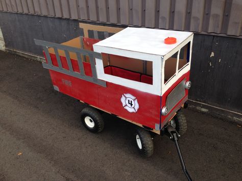 Cardboard fire truck wagon Diy Firetruck Wagon Cardboard, Firetruck Wagon Diy, Fire Truck Wagon Halloween, Fire Truck Wagon Diy, Zoo Wagon Halloween, Cardboard Fire Truck, Diy Fireman Costumes, Cardboard Fire, Kids Parade Floats