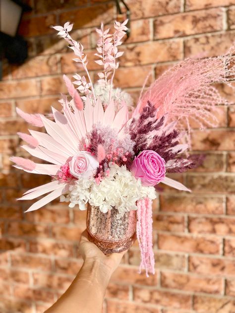 Pink dry   Floral arrangement glass vase with pink roses and pink palm leaves Flower Feather Centerpieces, Pink Boho Flowers, Pink Pampas Centerpiece, Light Pink Floral Arrangements, Pink Wedding Floral Arrangements, Feather Arrangements, Grass Centerpiece, Flowers For Spring, Wedding Floral Arrangement