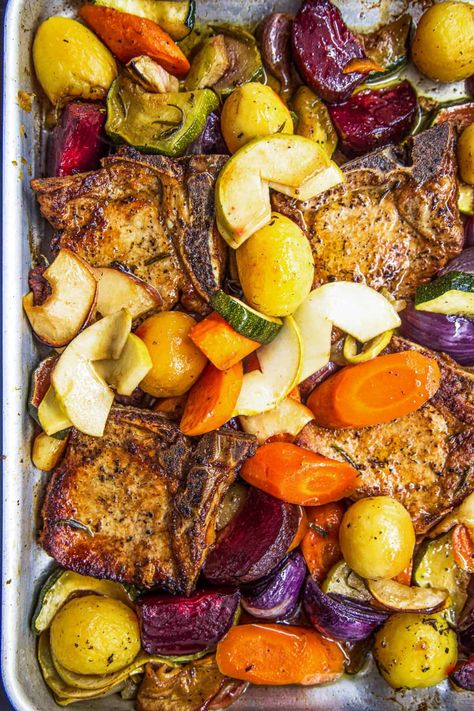 If you’re looking for the perfect autumn-themed dinner, this easy recipe for Baked Pork Chops with Apples and Vegetables is it! Thick-cut pork chops are seared and cooked in apple juice, with a colorful collection of apples, garlic, and winter veggies. Baked Pork Chops With Apples, Center Cut Pork Chop Recipes, Apple Pork Chop Recipes, Pork Chops Baked, Sheet Meals, Pork Loin Chops Recipes, Baked Boneless Pork Chops, Pork Chops With Apples, Balsamic Pork Chops