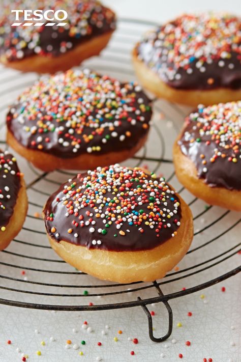 Try something new in the kitchen and make homemade doughnuts. These light and fluffy doughnuts are topped with a chocolate glaze and plenty of sprinkles for a treat that is totally worth the effort. | Tesco Doughnut Recipes, Glazed Doughnut, Homemade Donuts Recipe, Homemade Doughnuts, Tesco Real Food, Recipes Baking, Homemade Donuts, Doughnut Recipe, Chocolate Glaze