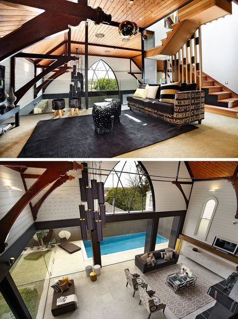 This modern church conversion has a mezzanine level that's home to a rumpus room and that overlooks the living room void and and has valley views through the large arched window. #ChurchConversion #Mezzanine Master Ensuite Bathroom, Dark Wood Dining Table, Rumpus Room, Timber Ceiling, Architecture Elevation, Modern Church, Master Ensuite, House Design Kitchen, Arched Windows