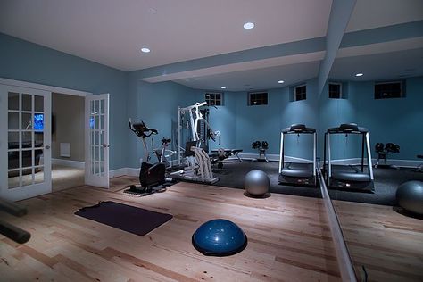 Like the happy blue color and wood floor in this exercise room. Home Gym Paint Colors, Ruang Gym, Basement Home Gym, Basement Gym Ideas, Modern Home Gym, Home Gym Basement, Workout Room Home, Modern Family Rooms, Basement Gym