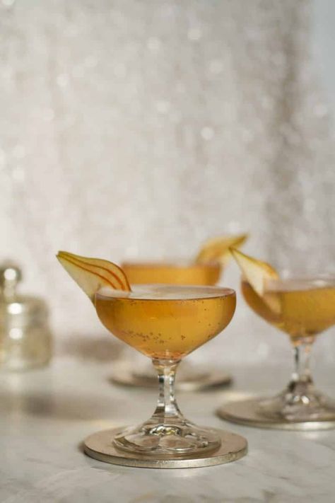 The Golden Night Cocktail Recipe — Salt & Wind Travel Golden Cocktail, Pear Brandy, Winter Dinner Party, Champagne Recipes Cocktails, Golden Night, Best Champagne, Sliced Pears, Fancy Cocktails, Oscars Party