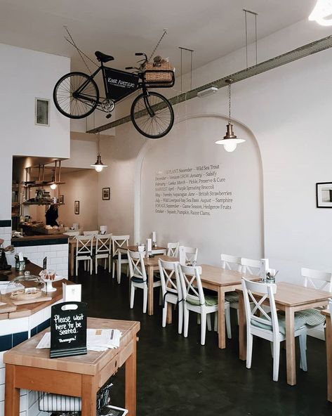 a hanging bike is a cool hipster touch to a coffee shop's interior Cafe Interior Design Small Cozy, Small Coffee Shop, Shop Sign Design, Small Cafe, Coffee Shops Interior, Shop House Plans, Interior Display, Shop Window Design, Shop Front Design