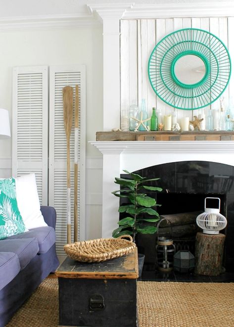 These fireplaces are decorated with sea inspired coastal theme focal points such as this turquoise mirror above the fireplace and a mantel with oceanic bottle vase. To see many more fireplace decorating ideas with a coastal theme click over to Completely Coastal. Fireplace Decorating Ideas, Coastal Fireplace, Fireplace Decorating, Rustic Beach House, Beach House Coastal, Wicker House, House Coastal, Fireplace Mantles, Yard Sale Finds