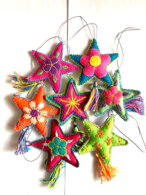 These ornaments are hand embroidered and appliquéd felt lovingly made by me here in Chicago. Brightly colored and tasseled, each ornament is unique. They are perfect for your tree, as party favors, accent notes throughout your home, or adding to a gift bag or wine bottle.  Each piece is one-of-a-kind and colors will vary. You will receive pieces chosen at random. They will be similar to those shown in photos, however colors and designs will vary since each is unique. Approximate size excluding loop and tassel is 3.25" x 3.25" x 0.5". These ornaments are embroidered on one side with a different solid felt color on the back. Anthropology Ornaments, Embroidered Xmas Decorations, Boho Ornaments Christmas, Homemade Felt Ornaments, Felt Embroidered Christmas Ornaments, Handmade Christmas Tree Ornaments, Felt Embroidered Ornaments, Felt Star Ornaments, Felt Embroidery Ornaments