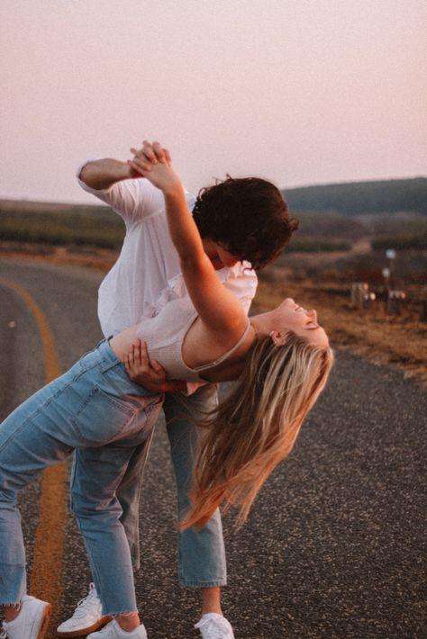 Couple dancing on the side of the road during sunset. Couple Photoshoot On Road, Couple Photography Poses On Road, Couples Dancing Poses, Hands On Legs Couple, Dancing Couple Pictures, Adult Couple Photoshoot Poses, Couple Road Pictures, Couples Dancing Aesthetic, Dancing Photoshoot Couple