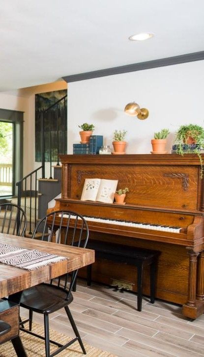 Piano Dining Room HGTV Fixer Upper Old-World Charm for Newlyweds. Modern Rustic Farmhouse. Piano By Fireplace, Piano In Dining Room Upright, Piano In Kitchen, Piano Next To Fireplace, Dining Room With Piano, Piano Dining Room, Dining Room Piano, Piano In Dining Room, Farmhouse Piano